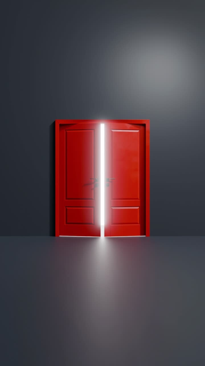 A bright light coming from behind a red door