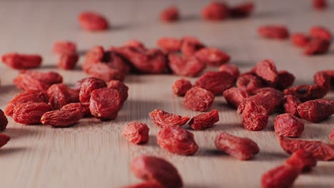 dried goji berries on wooden surface