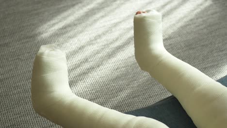 little child boy with plaster bandage on leg