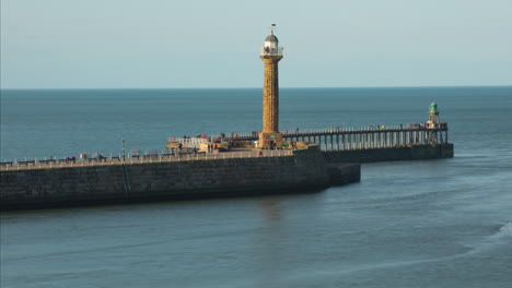 Whitby-Pier-Evening-Sunshine-with-crowds-of-tourists-on-the-pier-and-pleasure-cruises-passing