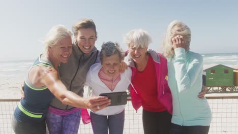 athletic women taking picture on the beach