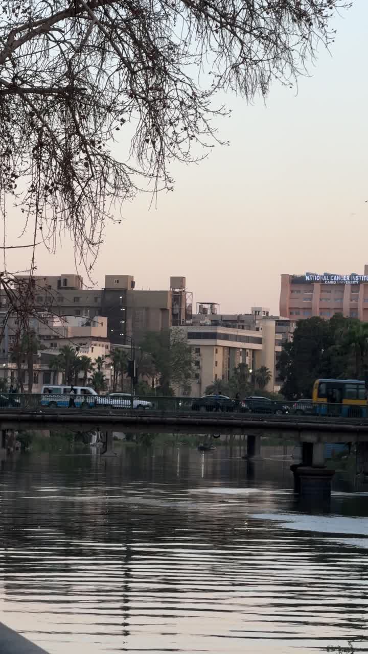 A view of buildings and bridge overlooking on Nile, close up shot, trucking shot