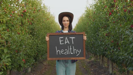 woman in apple orchard promoting healthy eating