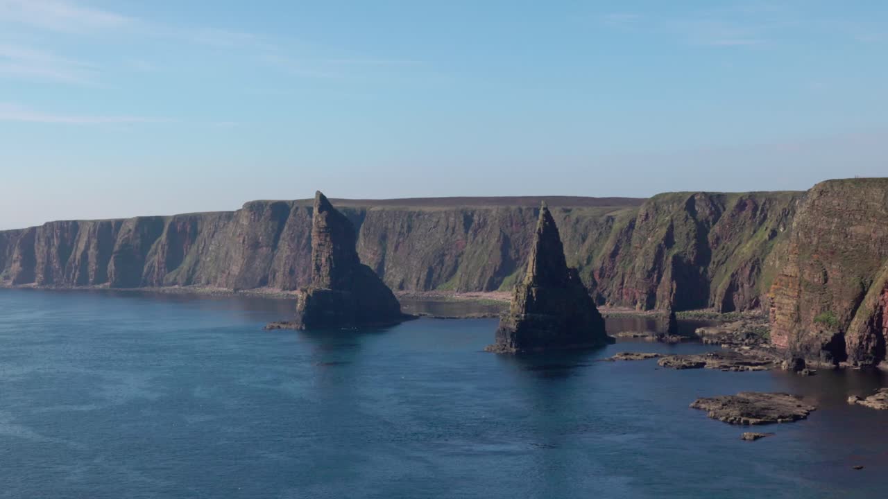 medium shot of the Duncansby sea stacks with turquoise waters near John O'Groats