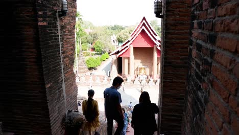 people entering and exiting a historic temple