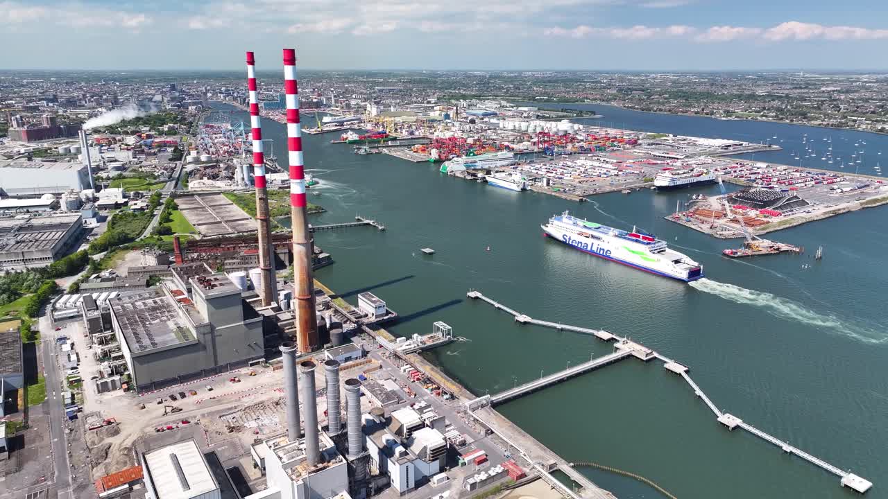 Ship is sailing to the Dublin Port, aerial over Power Plant Chimneys, industrial landscape, Ireland.