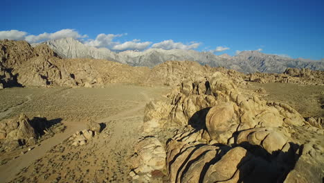 A-high-aerial-shot-over-the-Alabama-Hills-outside-Lone-Pine-California-with-Mt-Whitney-and-Sierras-background