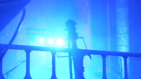 guitar bokeh on concert stage with light in background, motion view