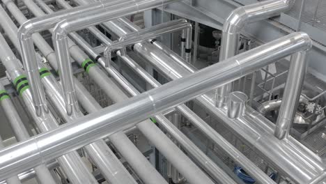 view from above of dense arrangement of silver insulated pipes in modern factory, industrial process, castets, france