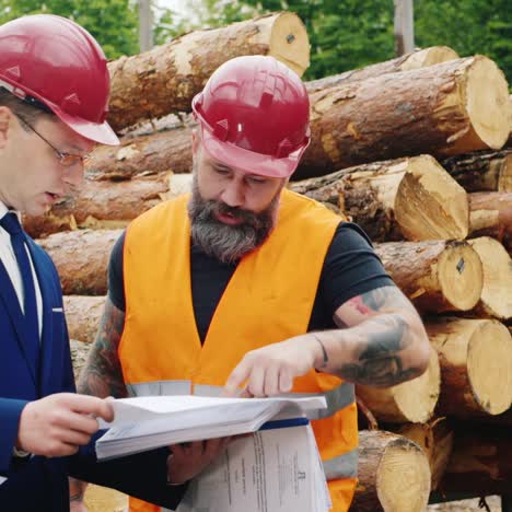 two engineers study the drawings with scaffolding in the background 1