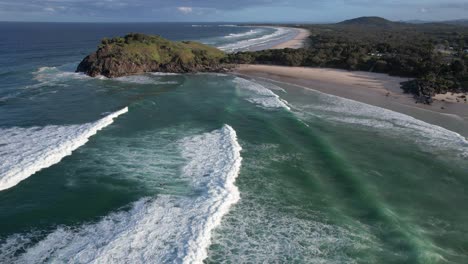 foamy surfing waves at cabarita beach near norries headland in northern rivers, new south wales, australia. aerial shot