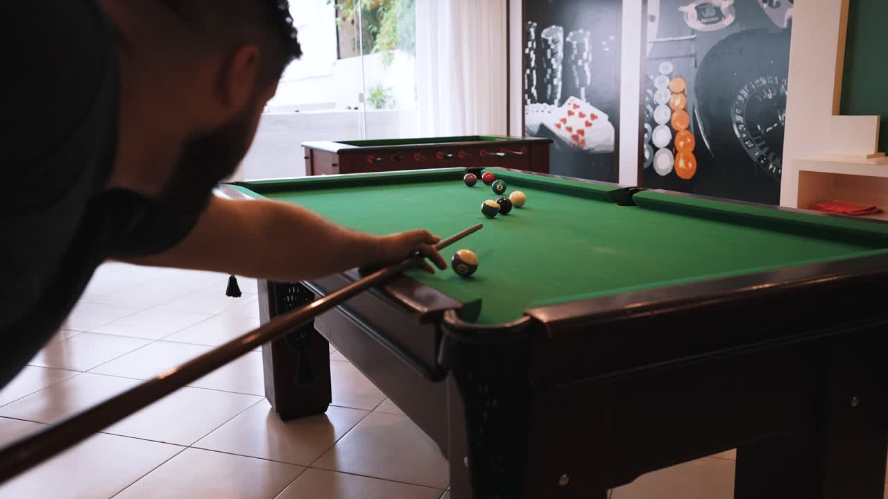 Billiard casual player hitting white cue ball missing the shot
