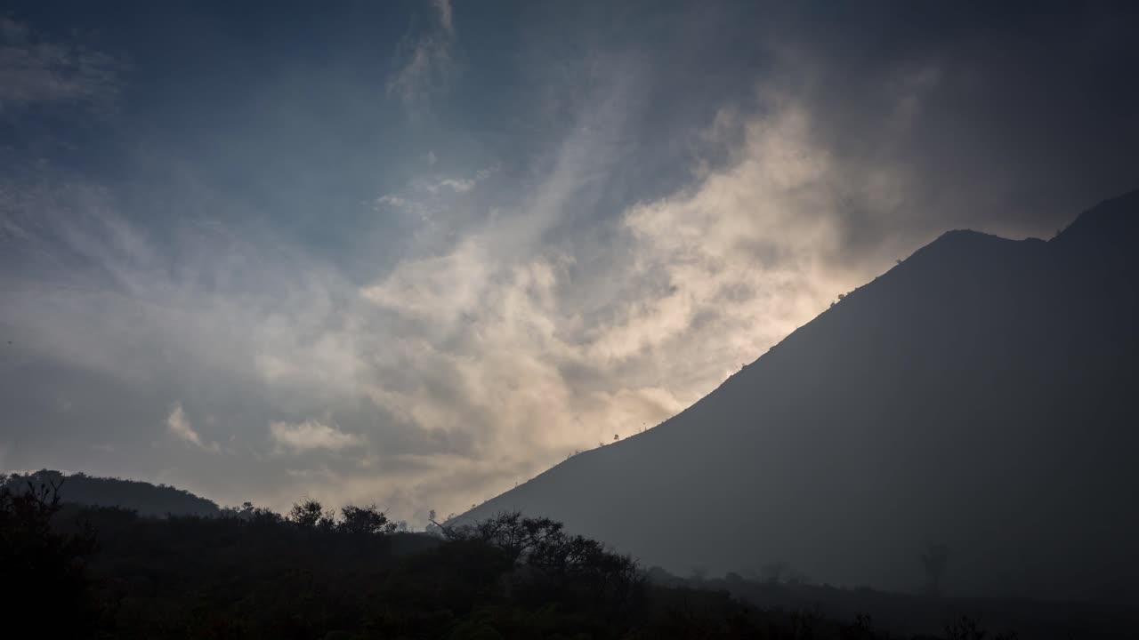 Timelapse of sunrise near Mount Ijen, with clouds and sun rays.