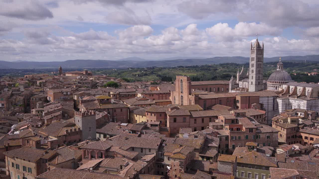 Aerial drone view of old buildings in Tuscany, Italy, on a cloudy day.