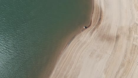 aerial view of a water reservoir at sunset with low water level in summer