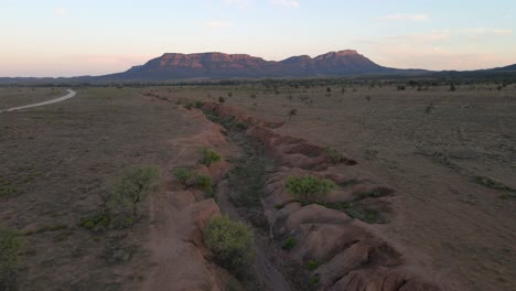 wilpena pound in distance, aerial pullback revealing idyllic outback landscape