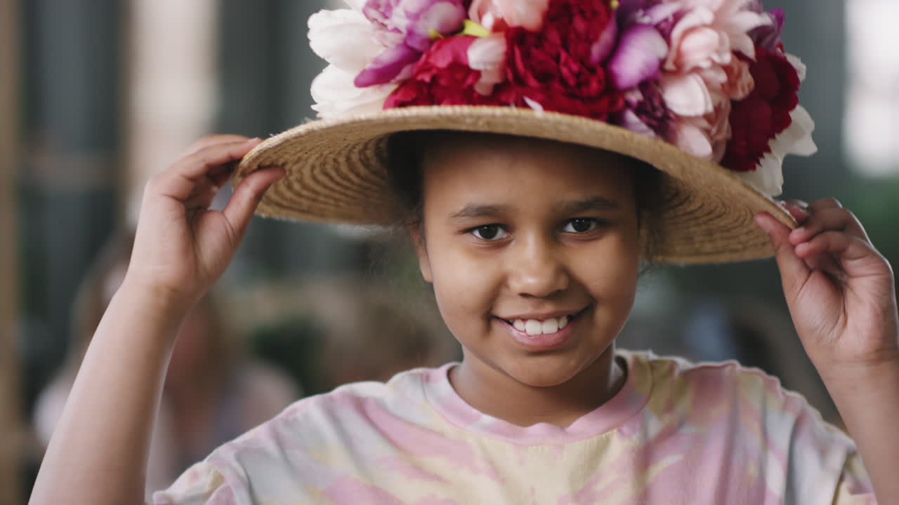Cute Girl in Hat Decorated with Flowers