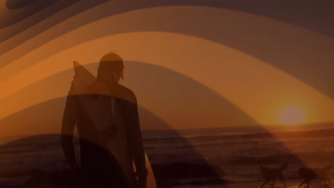 carrying surfboard, surfer walking along beach during sunset with ocean view