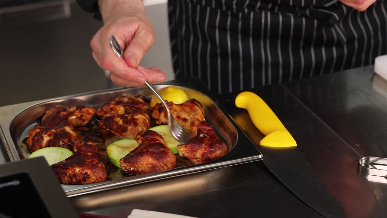 Chef preparing grilled chicken with lemon and zucchini