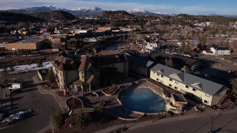 Pagosa-Hot-Springs-Resort-on-Sunny-Winter-Evening,-Orbiting-Drone-Aerial-View