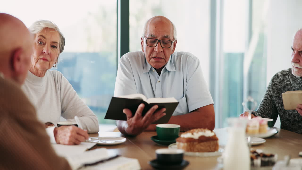 A group of seniors reading at a table