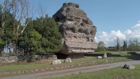 passing by a roman mausoleum on the appian way called mausoleo piramidale on a sunny day