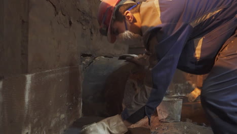 worker repairing a pipe in an underground facility