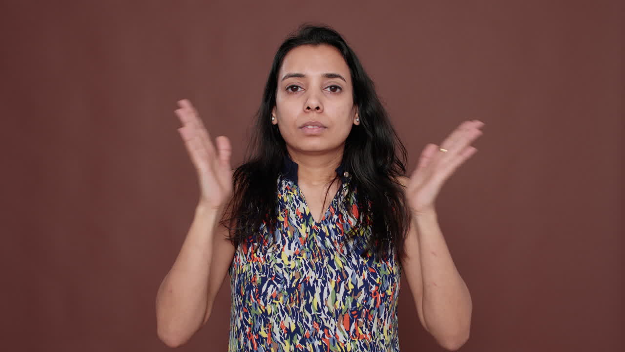 Portrait of indian peaceful woman doing zen meditation on camera