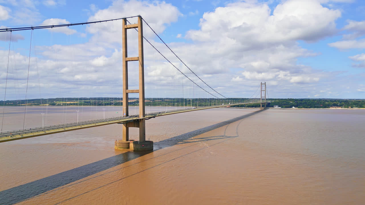 A drone's view of Humber Bridge: 12th largest single-span, spans River Humber, connecting Lincolnshire to Humberside amidst traffic