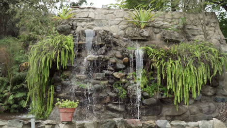 wide static shot of a waterfall feature in a garden in pachacamac, lima, peru