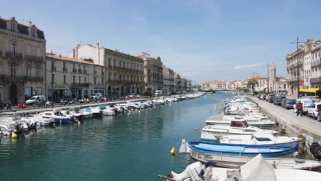 sete france view of the canal with docked boats residential area herault