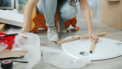 woman assembling a white table