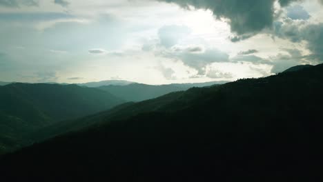 4k cinematic nature aerial footage of a drone flying over the beautiful mountains of chiang mai, thailand on a sunny day