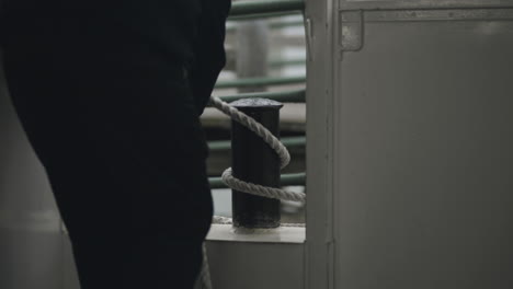 ship worker pulling the cruiser ship closer to the boardwalk secure the ship so that the passengers can safely exitthe cruising ship
