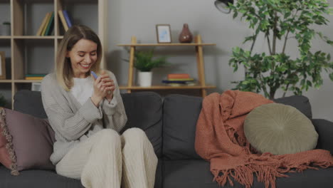 woman reacts to a positive pregnancy test