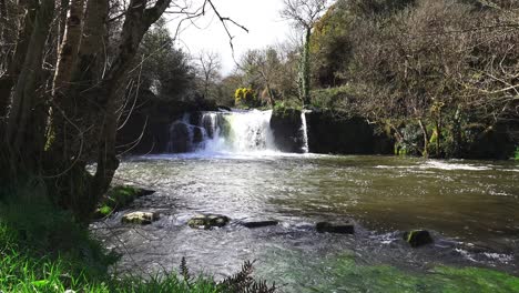 stepping stones and waterfall at poulassy kilkenny ireland in spring