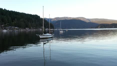 Sail-boat-in-the-calm-waters-of-the-Indian-Arm,-British-Columbia