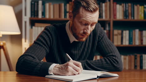 man writing in a library