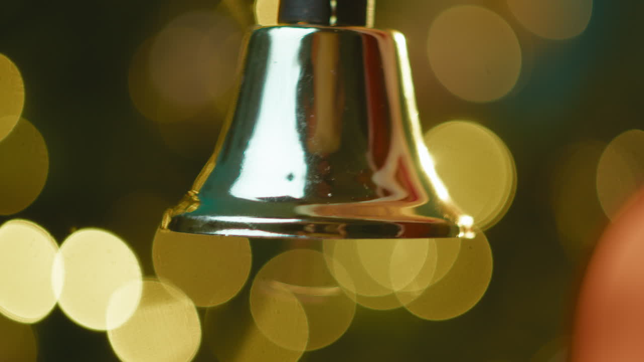 Bell rings vigorously in Santa Claus's hand At Christmas
