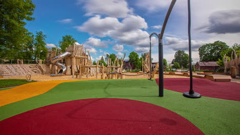 static shot of colorful playground floor along with wooden play equipment in an outdoor playground at daytime in timelapse