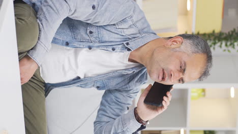 vertical video of man arguing with his wife on the phone.