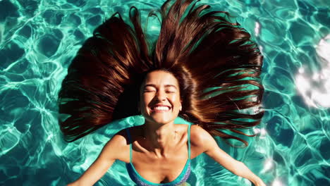 Young Woman Joyfully Swimming and Splashing in Clear Blue Water