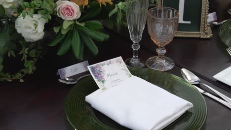 wedding invitation on table set for outdoor wedding reception