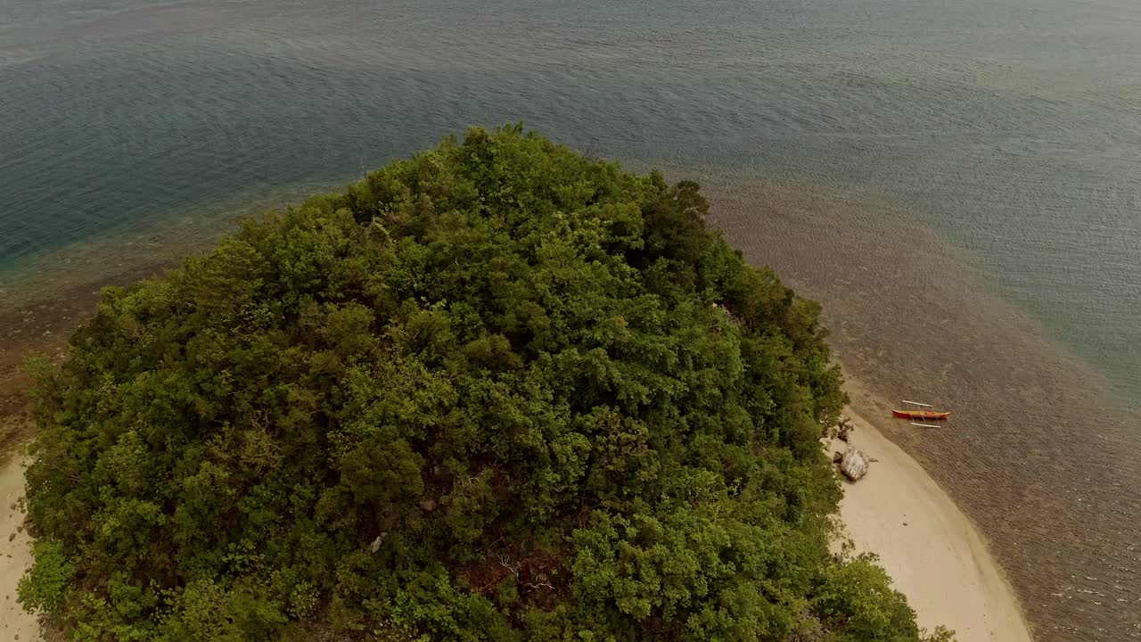 Aerial View Over the Small Malingin Island in the Philippines with Shallow Waters Surrounding the Island