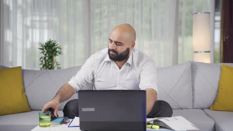 home office worker man getting good news on the phone.