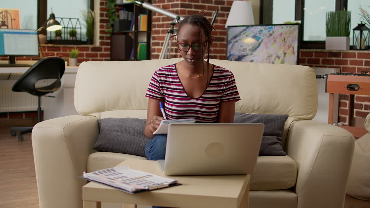 Woman studying at home with laptop