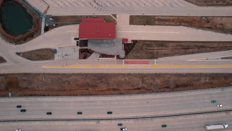 top down above highway and truck weigh station next to interstate