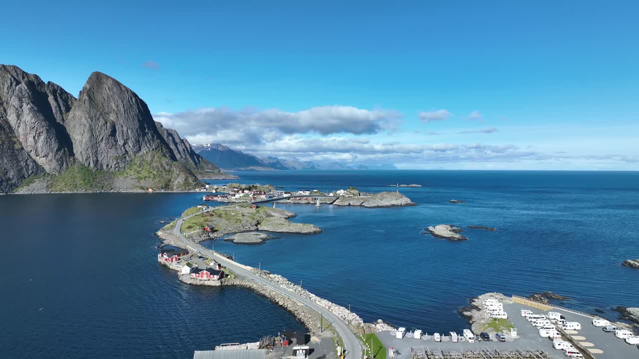 High aerial over E10 road from Reine to Hamnoy in Lofoten, crossing islands with Festhaeltinden in view