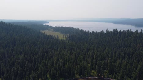 drone shot of a golf course next to lake payette and surrounded by a deep green pine forest