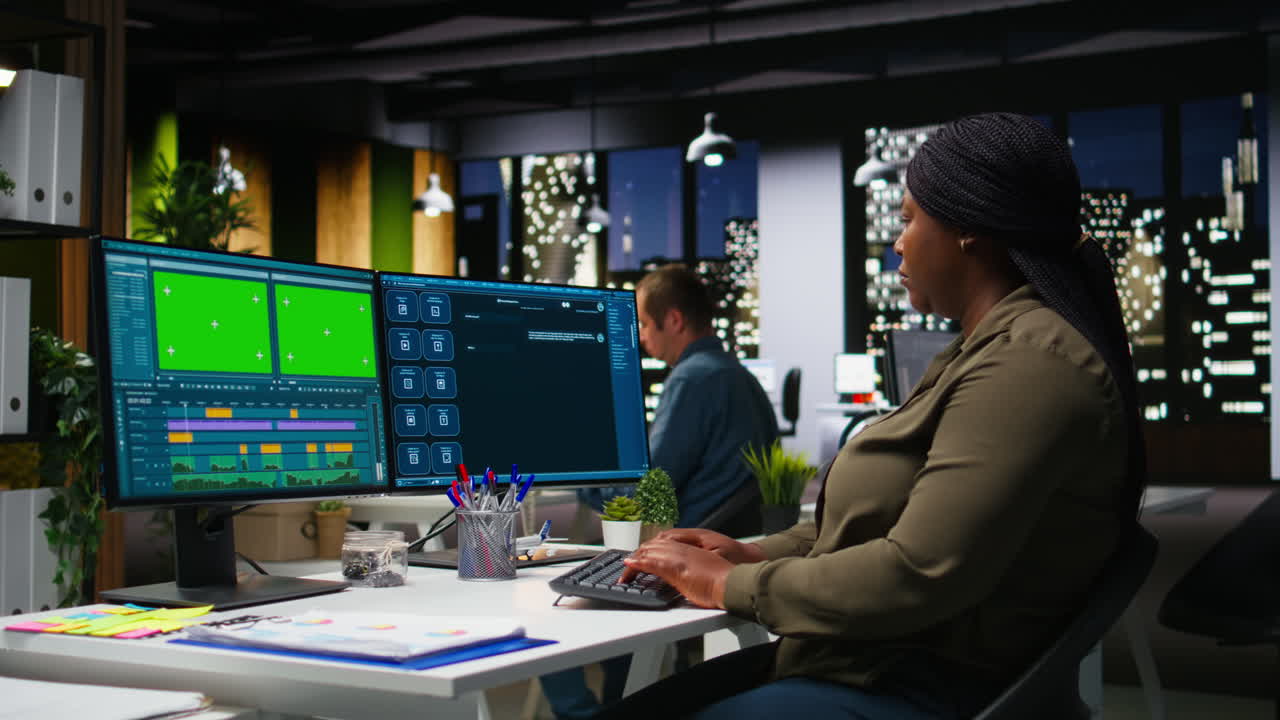 Green screen of black skilled female video editor working in creative office